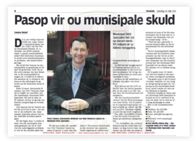 beeld-warns-public-on-section-118 - Municipal Debt Specialist Man in a dark suit sits at a desk on a newspaper front page about municipal debt and finances