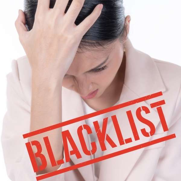 Woman in a light blazer holds her head in distress while a bold red 'BLACKLIST' stamp overlays the image.